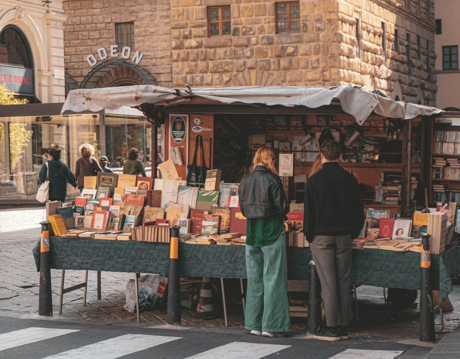 dipen-patel-gJw2ZYRLo_8-unsplash-2 A person browsing books at an autumn book fair for the October 2025 free book promo